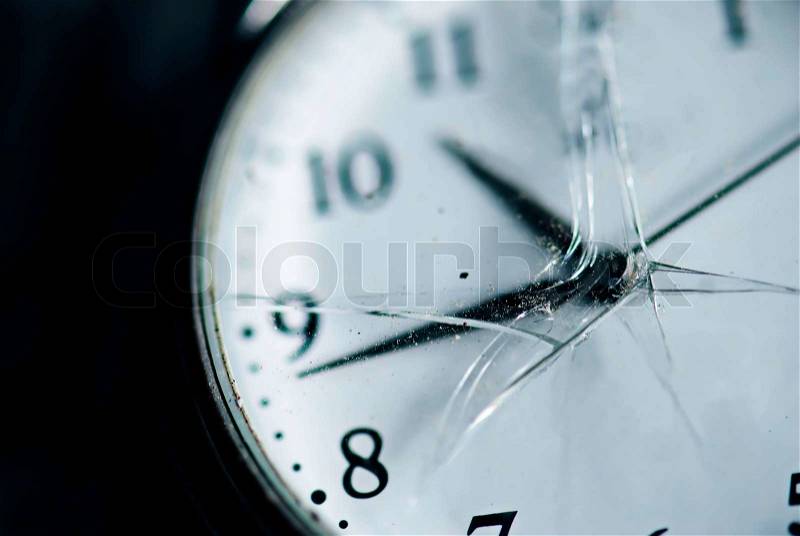 Broken time concept. Old dusty pocket clock with broken glass. Shallow depth of field. Blue tinted image, stock photo