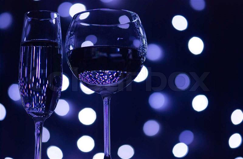 Abstract composition: champagne and vine glasses over lights background, stock photo