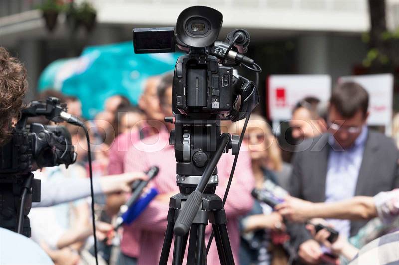 Filming an event with a video camera. Media interview, stock photo
