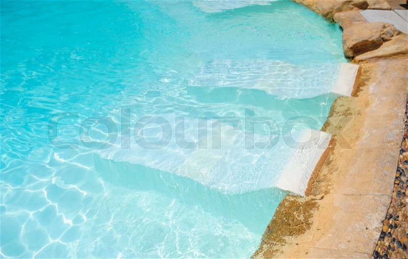 White deck chairs in the swimming pool, stock photo