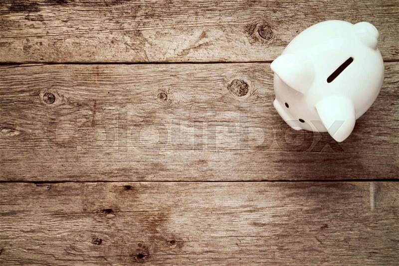Piggy bank on the old wooden background, top view, stock photo