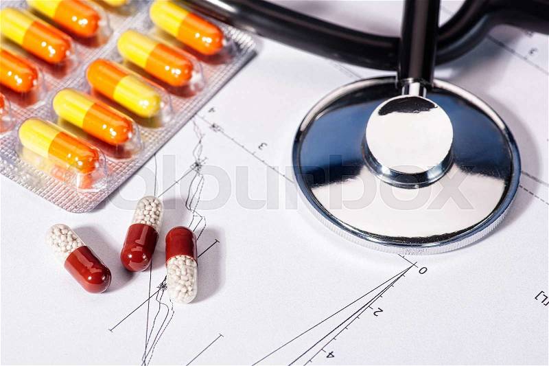 Abstract medicine backgrounds with pills, stethoscope over heart diagram, stock photo
