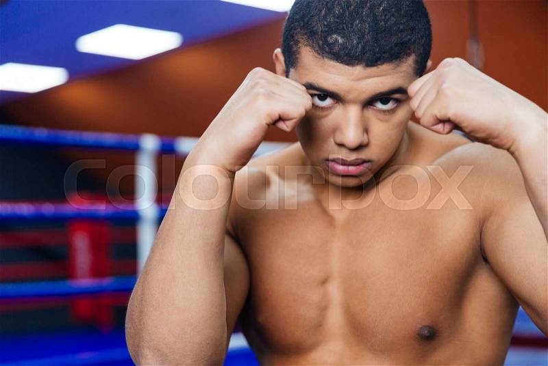 Portrait of a handsome male boxer workout in gym, stock photo