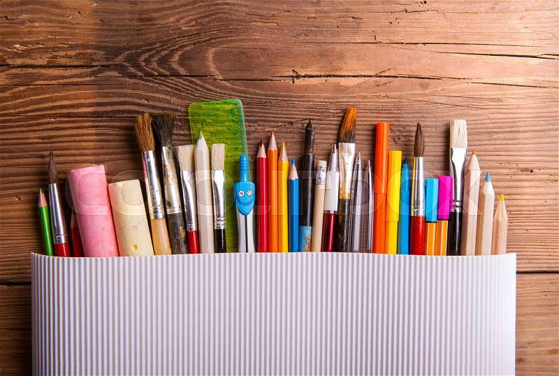 Various school and art supplies laid on table, flat lay. Studio shot on wooden background, copy space, stock photo