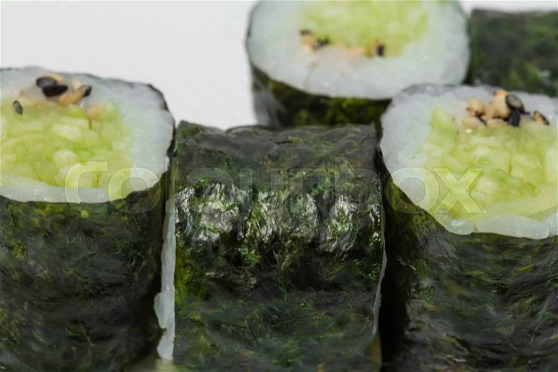 Traditional japanese vegetarian sushi roll with cucumber and sesame. As a whole background, stock photo