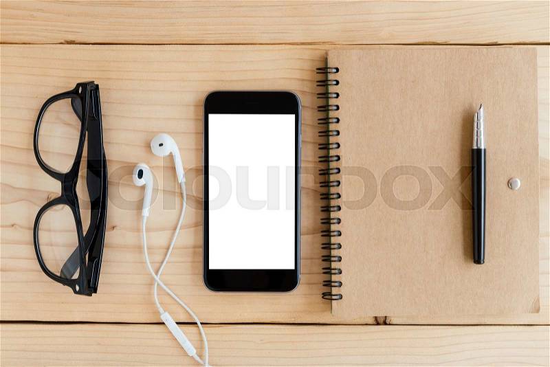 Phone white screen on wood workspace top angle view, stock photo