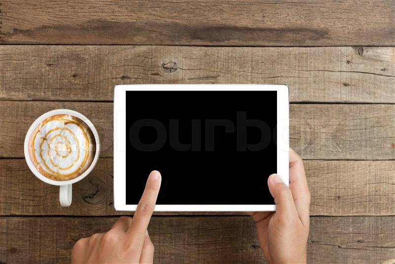 Hand using mock up tablet on wood desk with clipping path display easy add element, stock photo