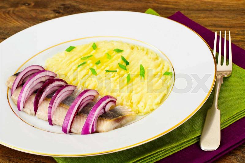 Mashed Potatoes with Herring and Red Pickled Onions Studio Photo, stock photo