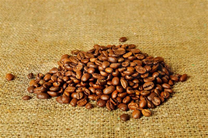 Heap of the coffee beans on the sack, stock photo