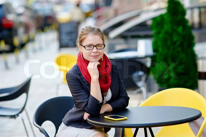 Young beautiful student girl with notepad in the cafe, stock photo