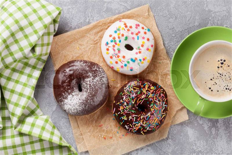 Donuts and coffee on stone table. Top view, stock photo