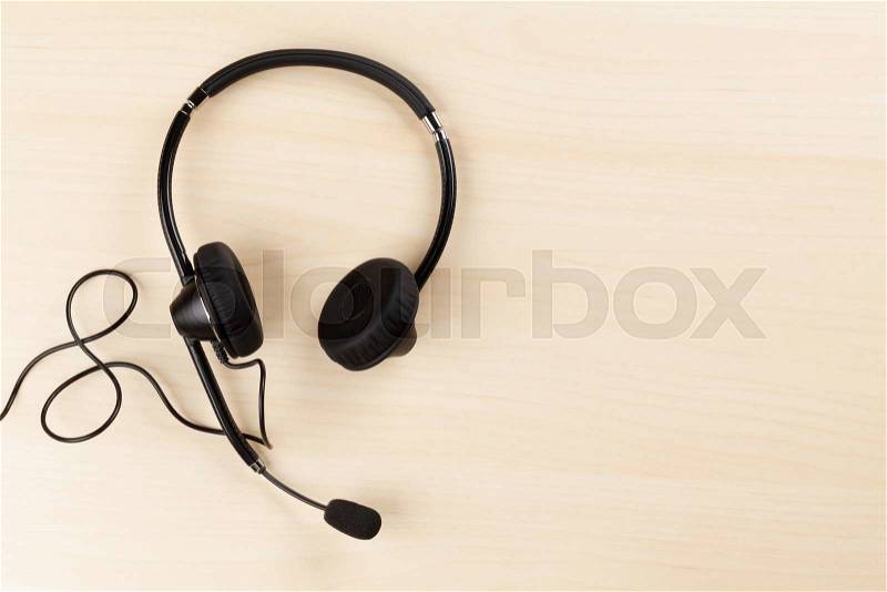 Office desk with headset. Call center support table. Top veiw with copy space, stock photo