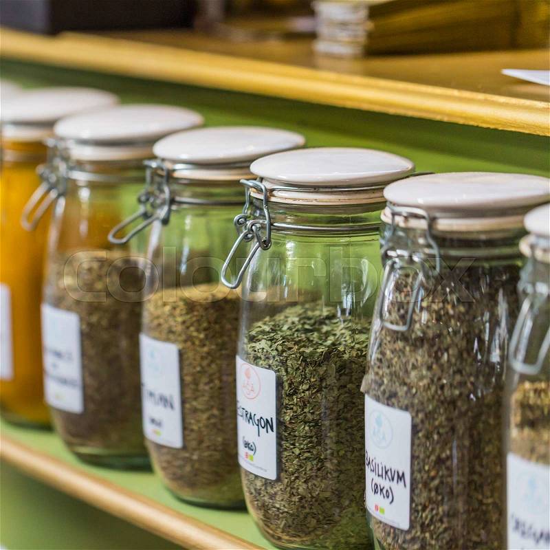 Assortment of glass jars on shelves in herbalist shop in marrakesh, morocco, containing herbs and spices for medicinal and culinary purposes , stock photo