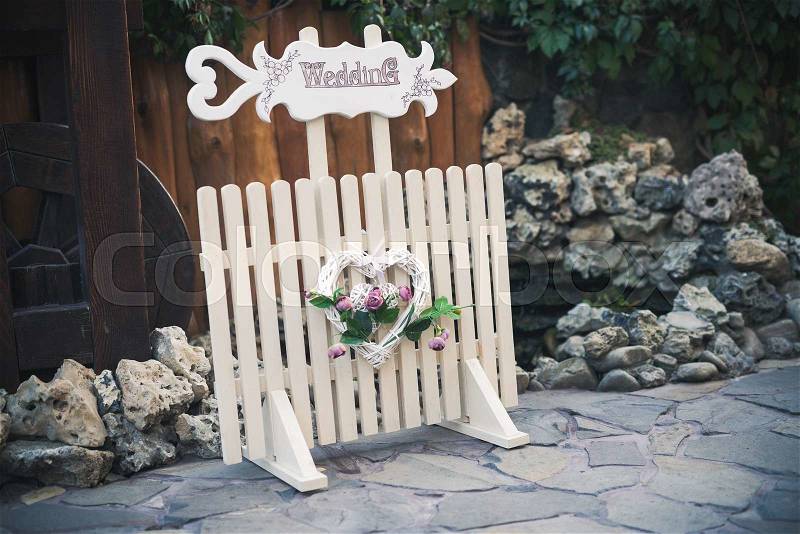 Pointer to the wedding celebration start. Sign wood, white nameplate, stock photo