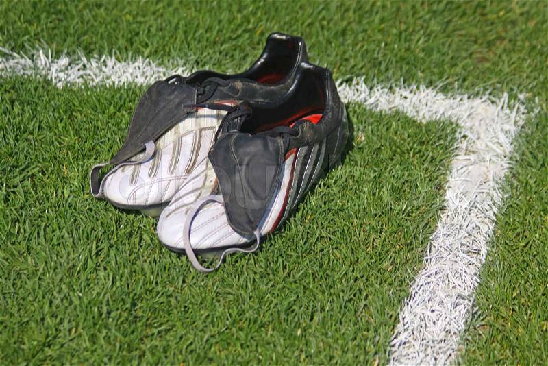 Pair of football boots on the grass, stock photo