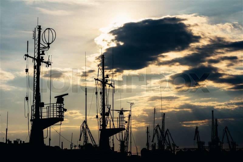 Silhouette of sea port at sunset, stock photo