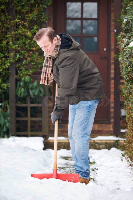Man Clearing Snow From Path With Shovel, stock photo