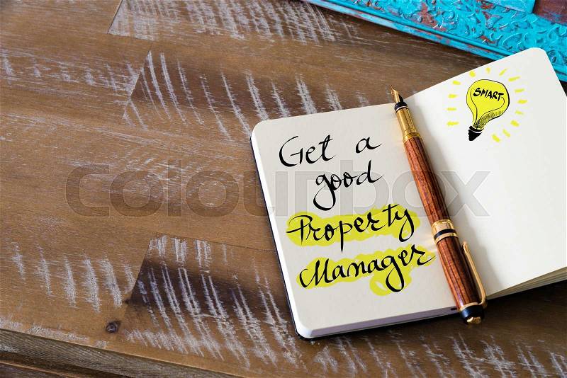 Retro effect and toned image of notebook next to a fountain pen. Business concept image with handwritten text GET A GOOD PROPERTY MANAGER, copy space available, light bulb as smart idea , stock photo