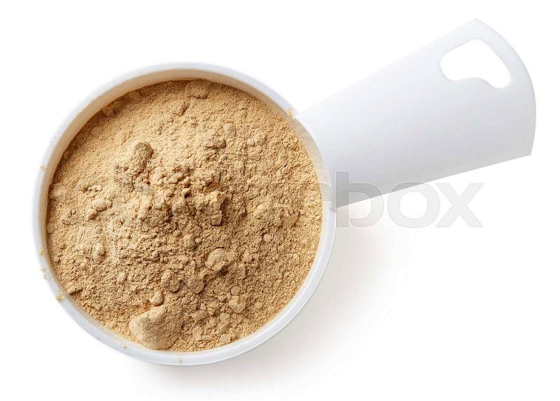 Measuring scoop of maca powder isolated on white background, top view, stock photo