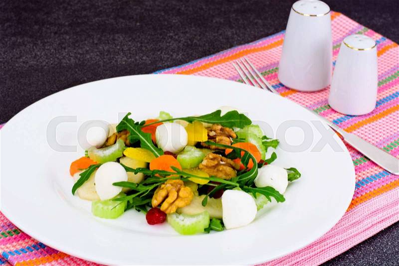 Dietary Delicious Salad on White Plate of Arugula, Par, Walnut and Dried Cherry. Studio Photo, stock photo
