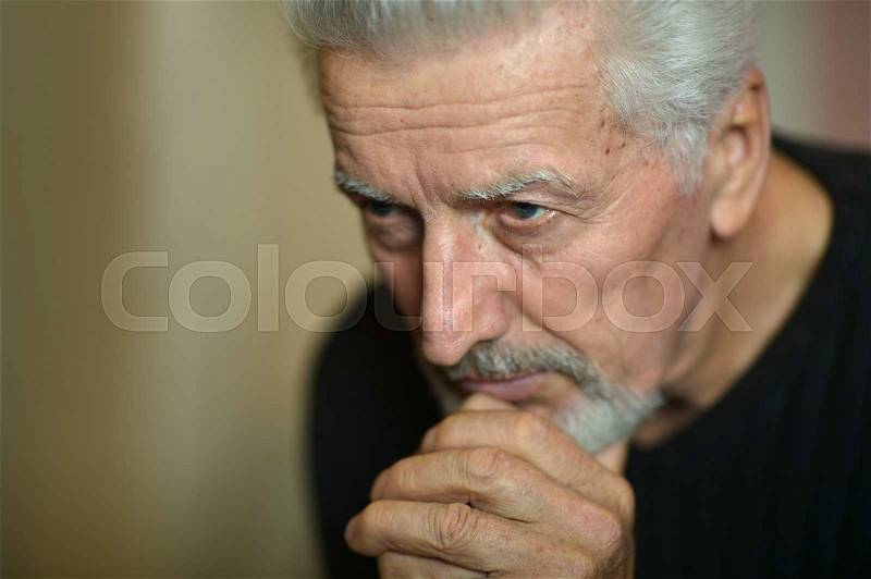 Portrait of Sad senior man at home, stock photo