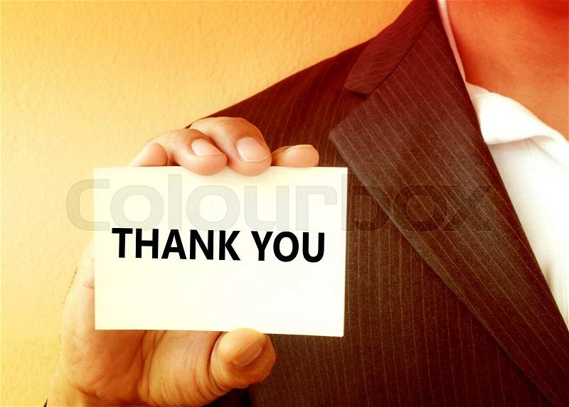 THANK YOU word on the white card shown by a businessman - vintage tone, stock photo