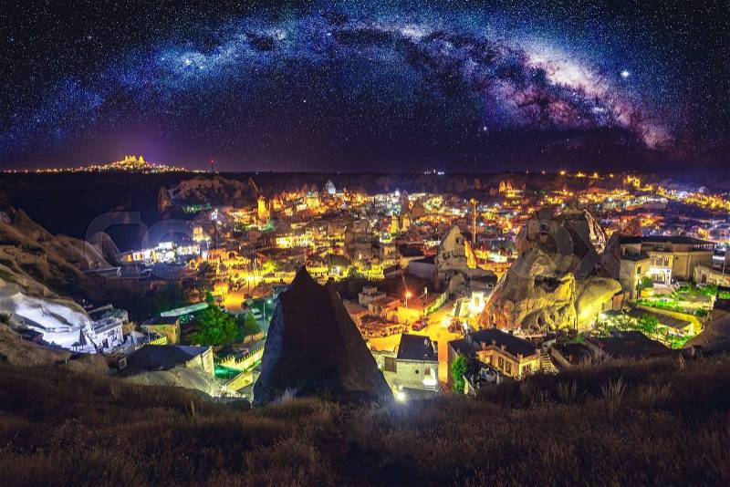 Ancient town and castle of Uchisar dug mountains, Cappadocia at night, Turkey, stock photo