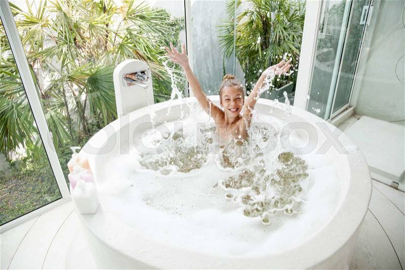 Kid girl washing with a foam in luxury hotel outdoor bath, still life, stock photo