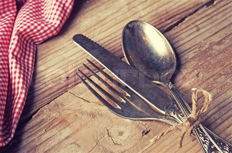 Old cutlery on wooden table, stock photo