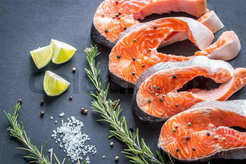 Raw trout steaks on the wooden board, stock photo