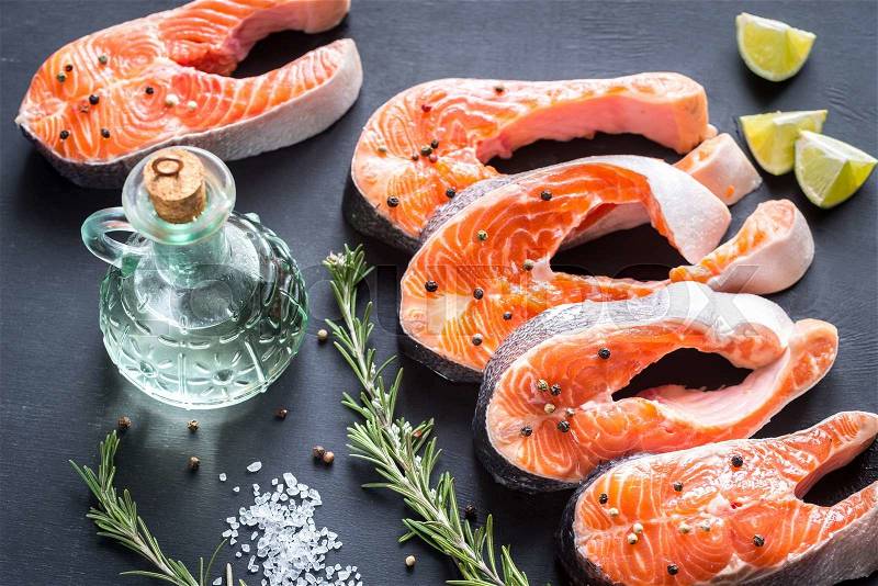 Raw trout steaks on the wooden board, stock photo