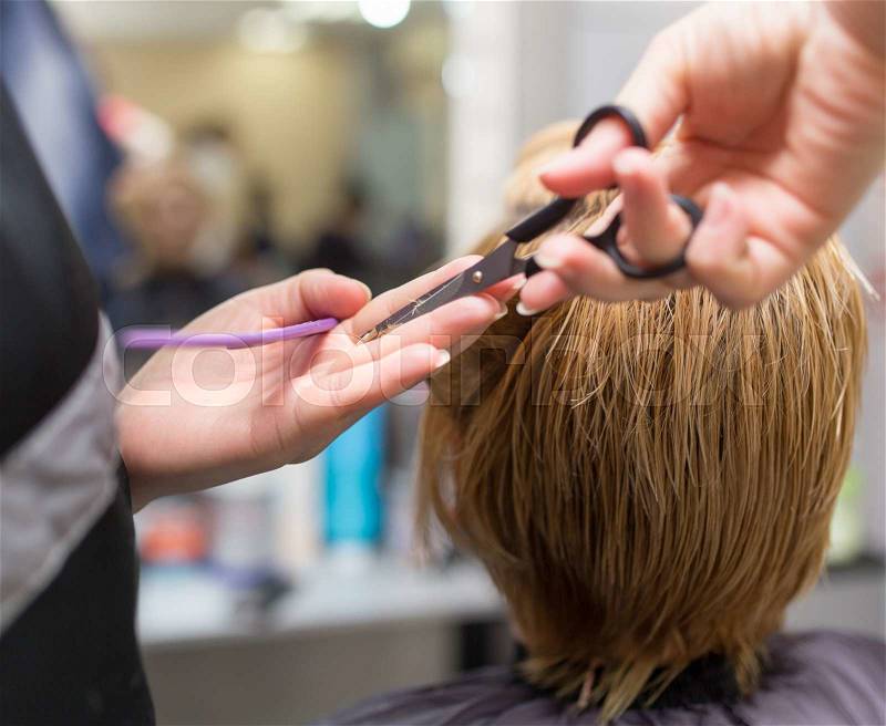 Female hair cutting scissors in beauty salon, stock photo