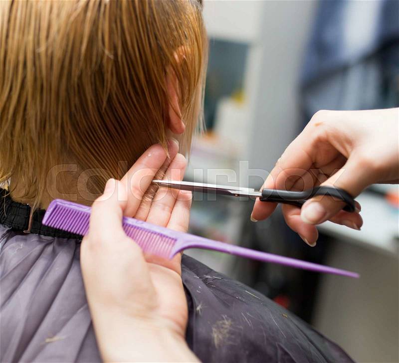 Female hair cutting scissors in beauty salon, stock photo