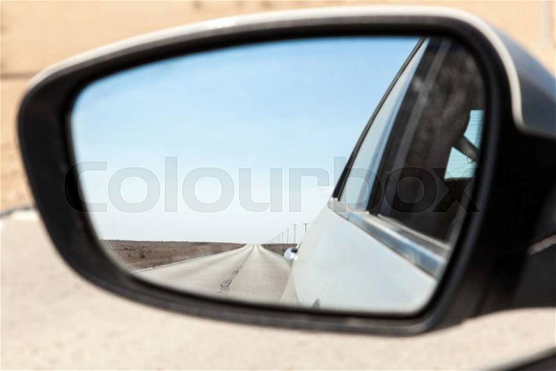 Desert road in Qatar in the rear view mirror of a car. Doha, Qatar, Middle East, stock photo