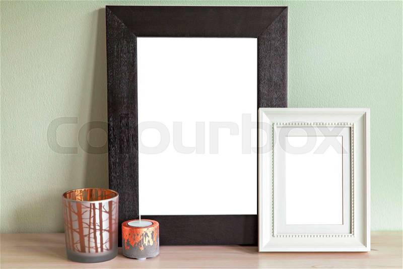 Image of mock up scene with two frames and decorative candle holders, stock photo