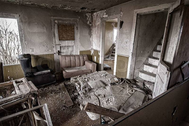 The inside of an abandoned house. This house has been abandoned for years and is showing the signs of vandalism and deterioration, stock photo