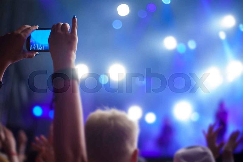 Silhouettes of people and musicians in big concert stage, stock photo