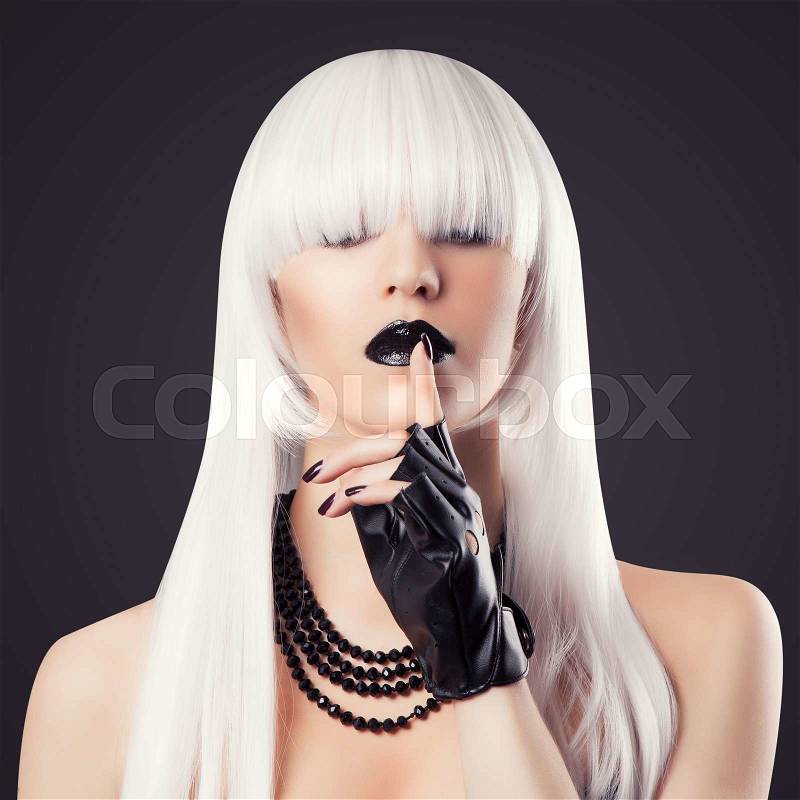 Beautiful blonde woman with black make-up and accessories making a hush gesture, stock photo