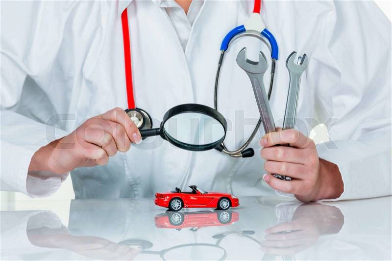 A model of a car is examined by a doctor. photo icon for workshop, service and car purchase, stock photo