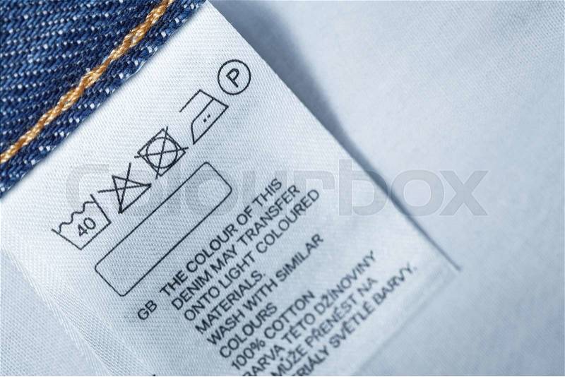 Clothing label with laundry care instruction, close up, stock photo