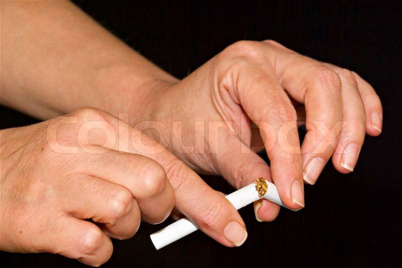 Hands break the cigarette, stock photo