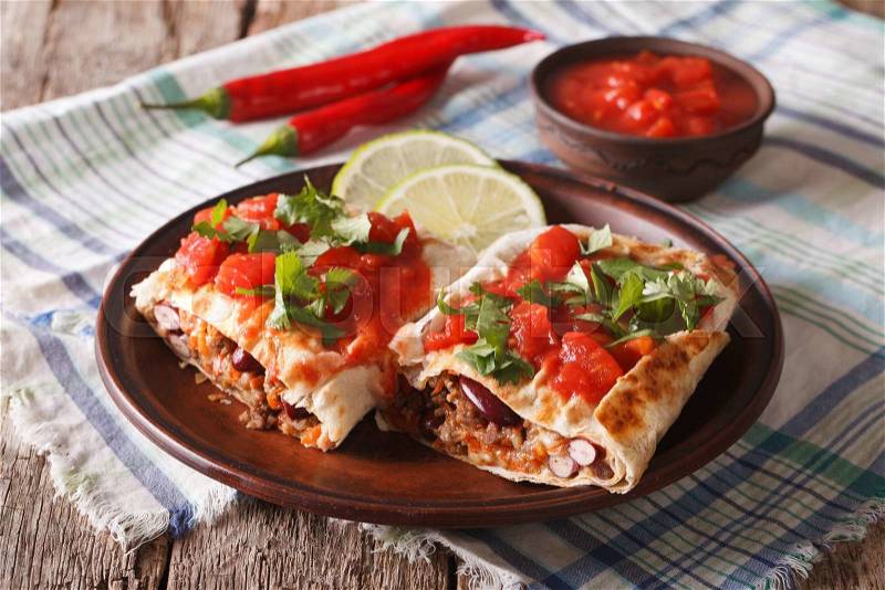 Chimichanga with ground meat, beans and cheese close-up on the table. horizontal , stock photo