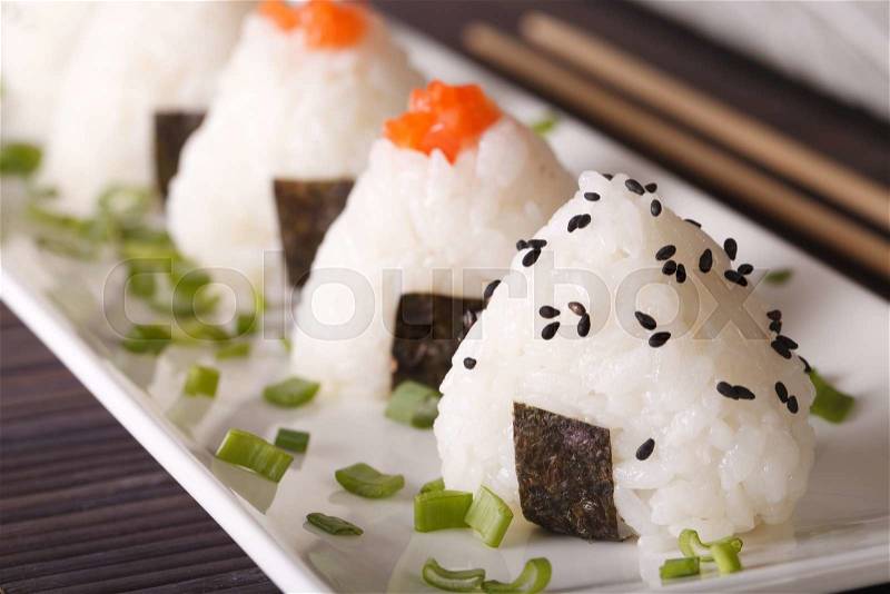 Japanese food onigiri rice balls macro on a white plate. horizontal , stock photo