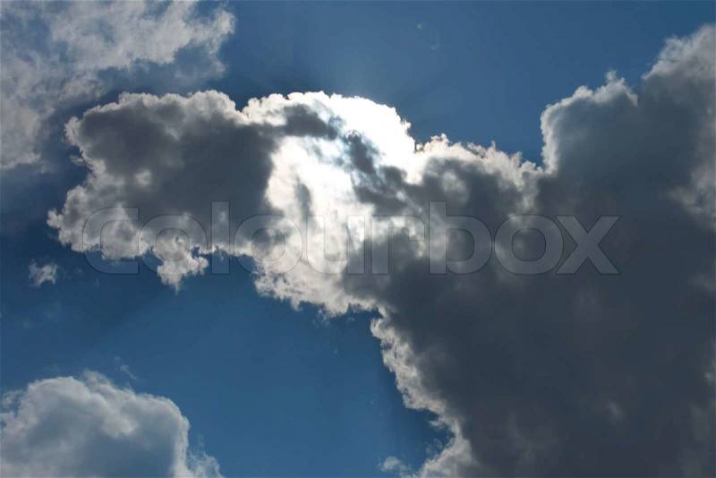 Cloudscape. The sun makes its way through clouds, stock photo