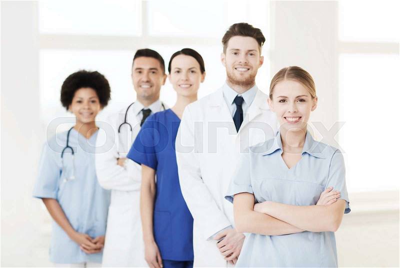 International, profession, people and medicine concept - group of happy doctors and nurses at hospital, stock photo