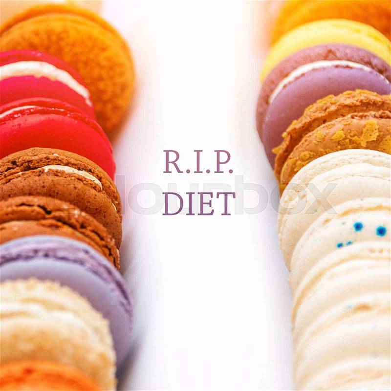 Traditional french colorful macaroons in a rows in a box with words RIP Diet, stock photo