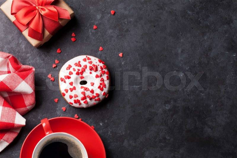 Donut, coffee and gift box on stone table. Top view with copy space, stock photo