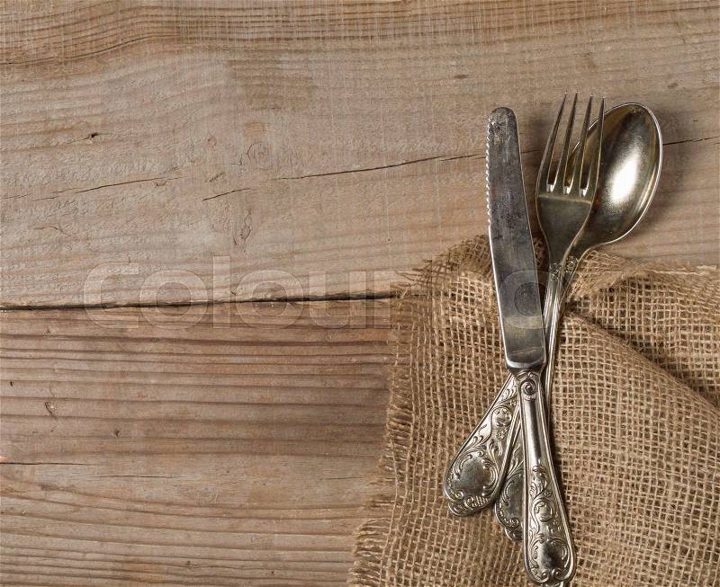 Old cutlery on wooden table, stock photo