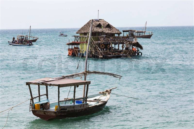 Boats in the Indian Ocean in the Zanzibar archipelago. Formerly a protectorate of the Sultanate of Oman, Zanzibar is now a semi-autonomous region of Tanzania, stock photo