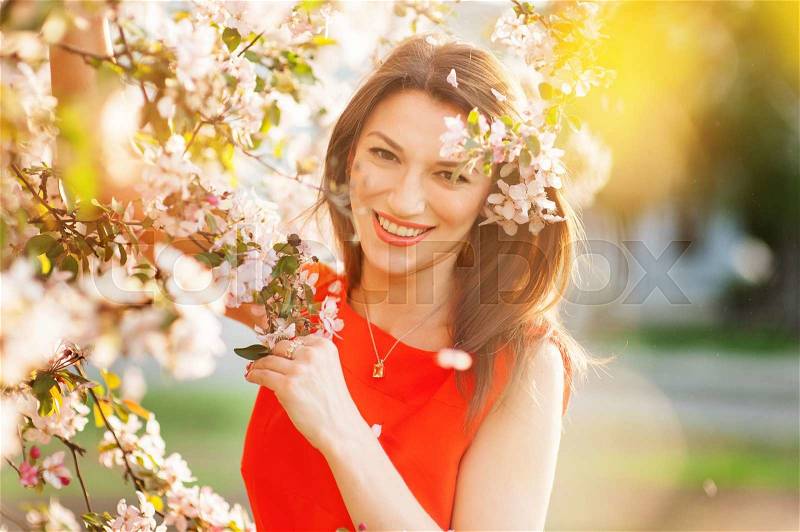 Sensual portrait of spring woman, beautiful face female enjoying cherry blossom, tree branch and glamorous lady, stock photo
